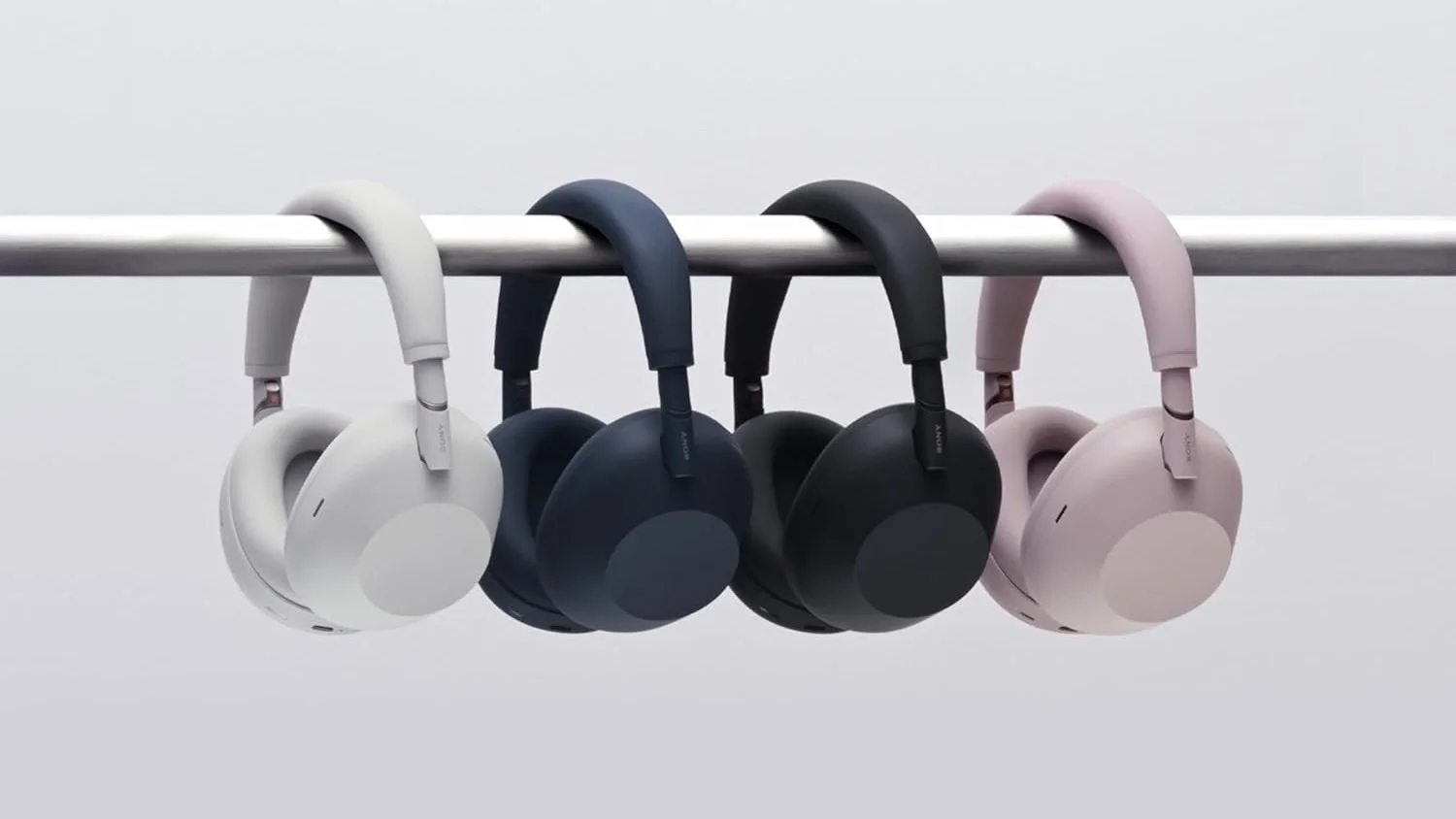 four pairs of sony xm6 headphones hanging from a pole