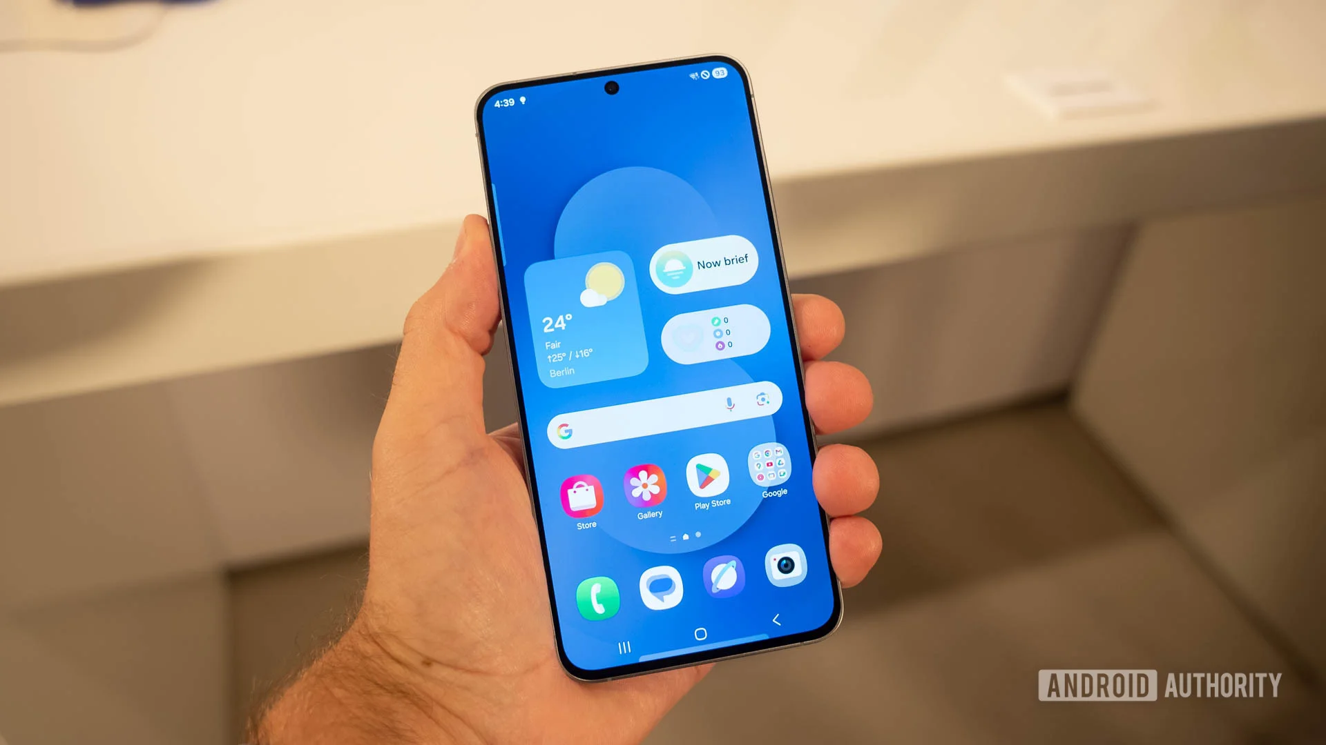 Samsung Galaxy S25 FE in man's hand showing home screen